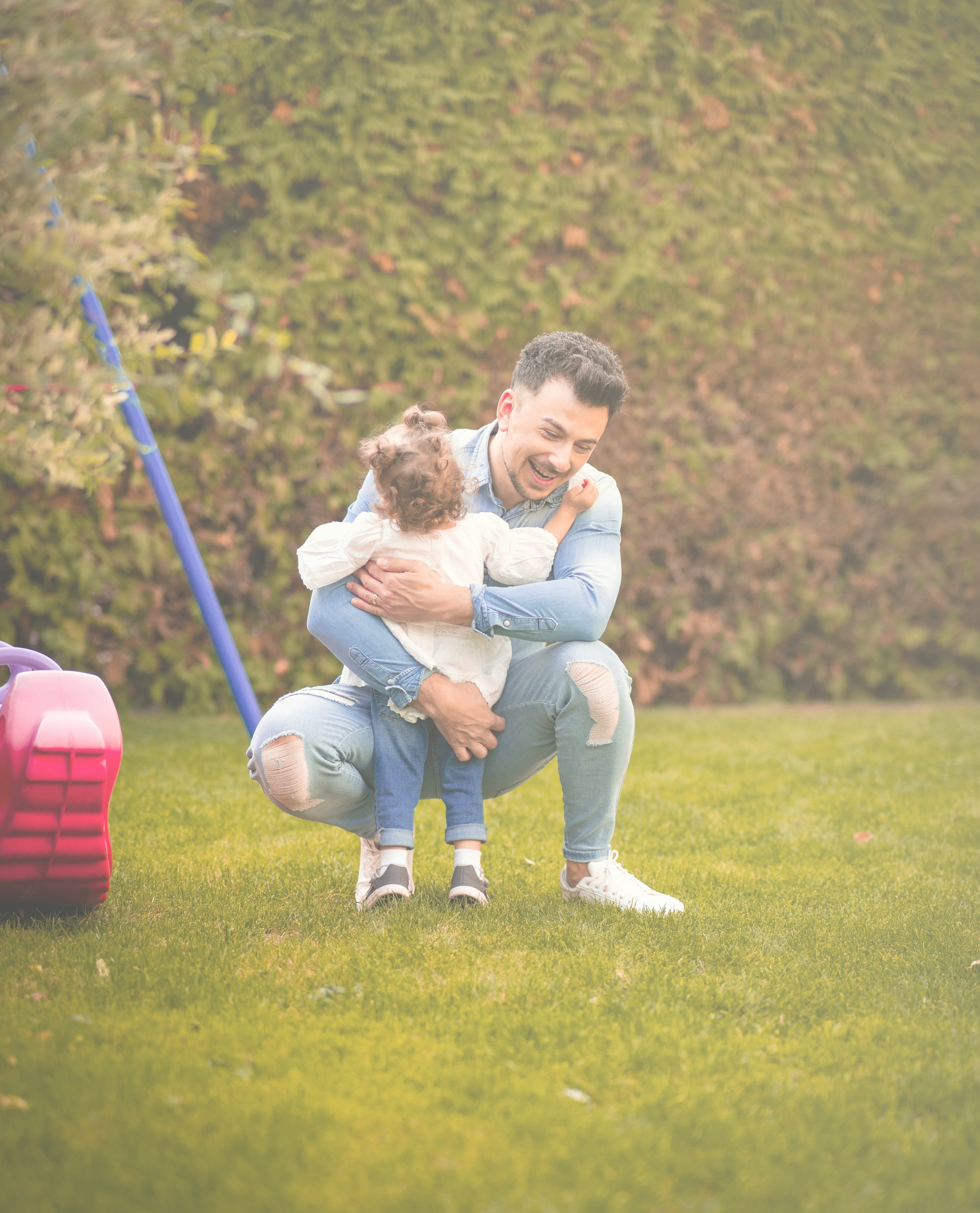 Happy father and child playing safely in their secure garden